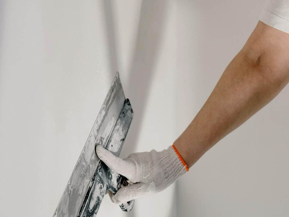 Plasterer at work on wall